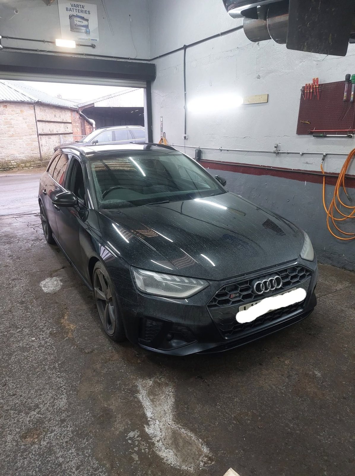 Dark grey Audi estate parked in the workshop
