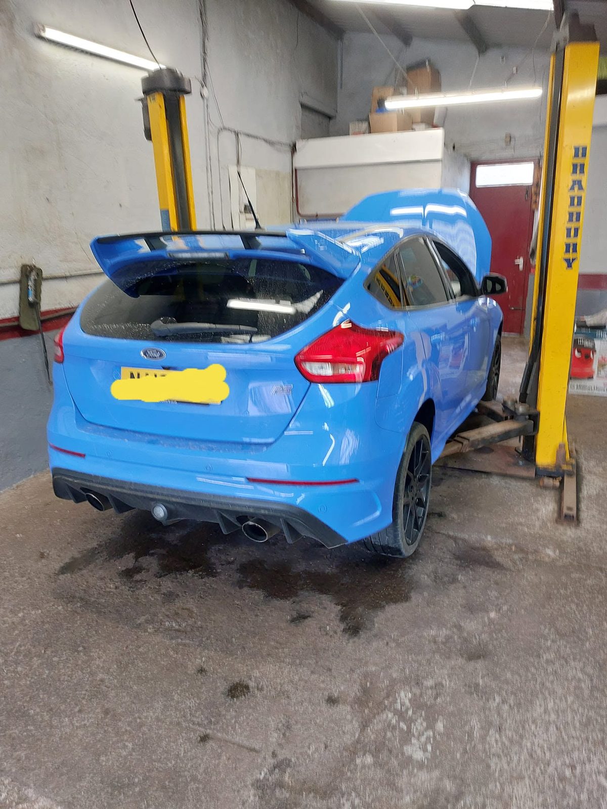 Blue Ford Focus RS from behind on the lift