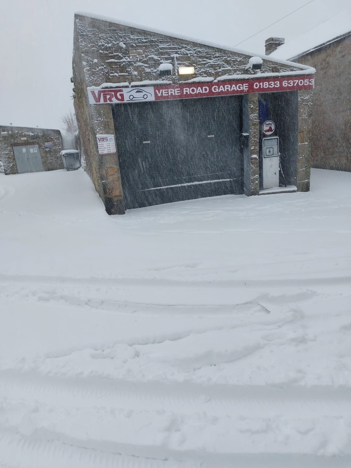 The workshop front in deep snow under the red VRG sign